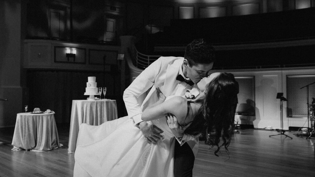 Black and white image of bride and groom kissing