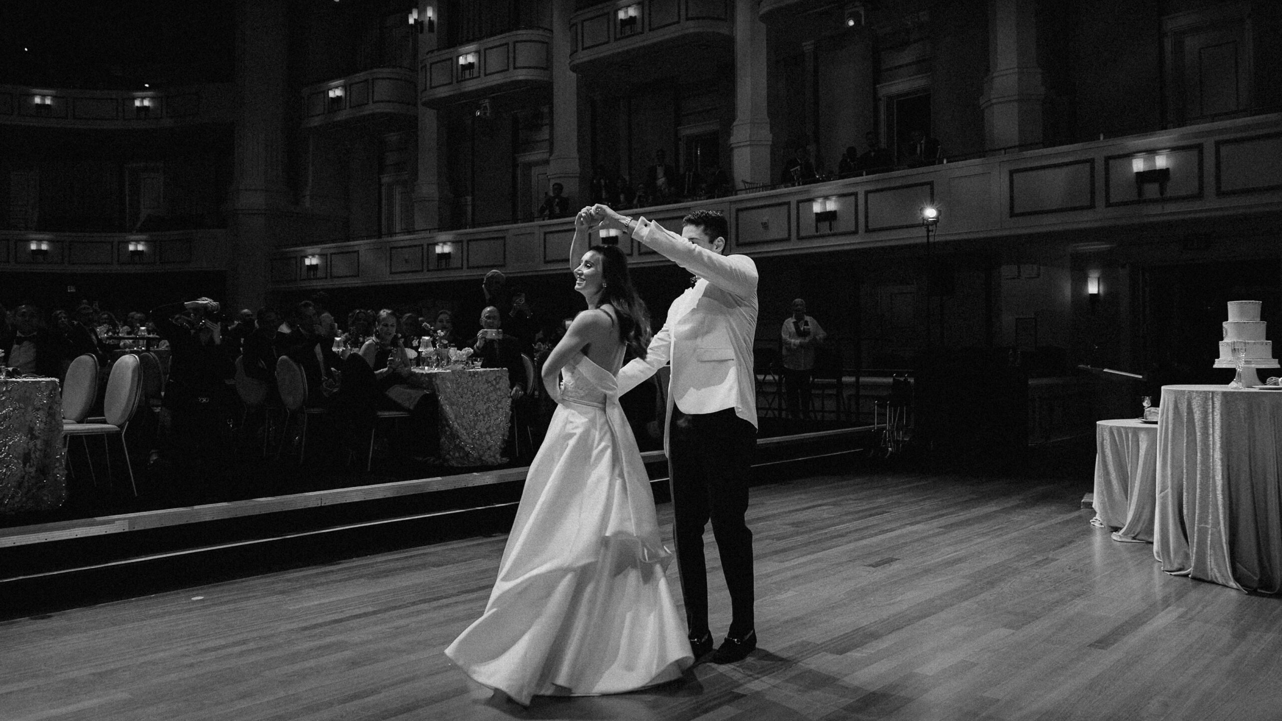 Black and white image of bride and groom dancing